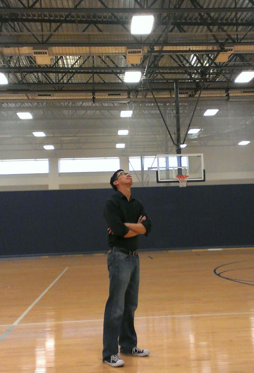 Kethia Chheng checks out the lighting in a basketball gymnasium